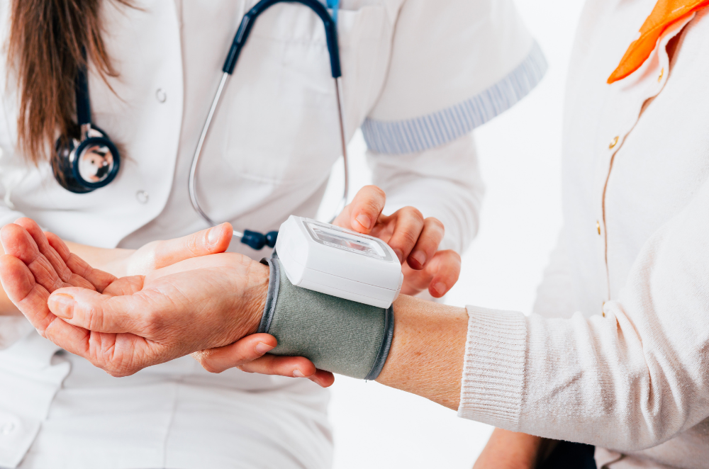 A person having a medical test done by a doctor wearing a stethoscope.