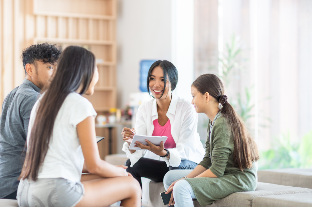 Family of four discussing life insurance.